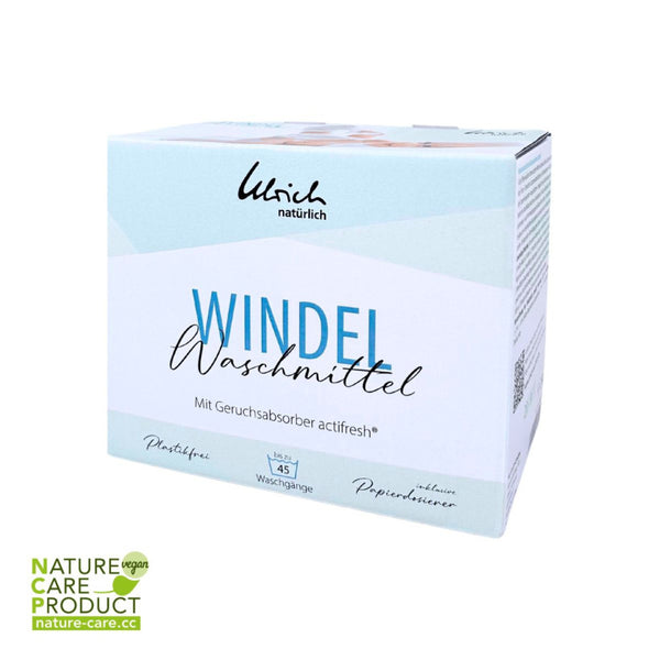 Eine weiße Dose Dr. Ulrich Natürlich Windelwaschmittel mit Geruchsabsorber "actifresh" 2kg, etikettiert für 45 Wäschen, vegan und umweltschonend, mit blauer und schwarzer Schrift und dem Nature Care Product vegan Logo unten links.